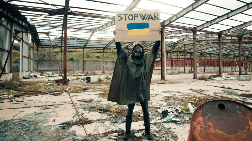 Boy with gas mask holds in hand cardboard with sto 2023 11 27 05 20 39 utc